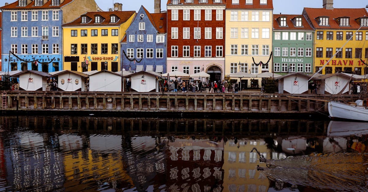 Casas coloridas refletidas no canal de Nyhavn em Copenhague, um dos melhores destinos para mochilão europa.