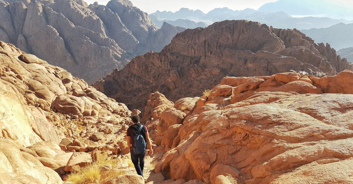 Hiker trekking through the rugged mountains of South Sinai, a region with active travel advisories for visitors