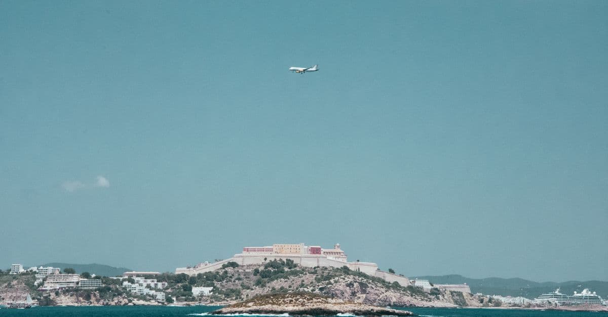 Ryanair flights to Ibiza approaching the island over the sparkling Mediterranean Sea