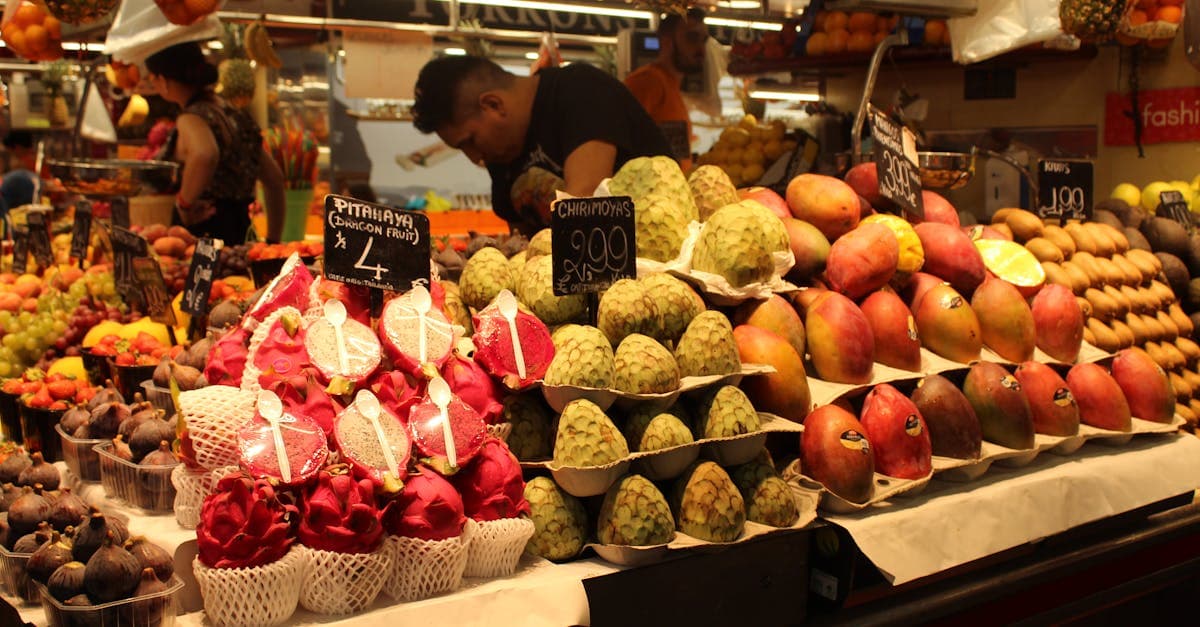 Fresh tropical fruits including dragon fruit and mango at a vibrant Barcelona market, showcasing what to eat in Spain