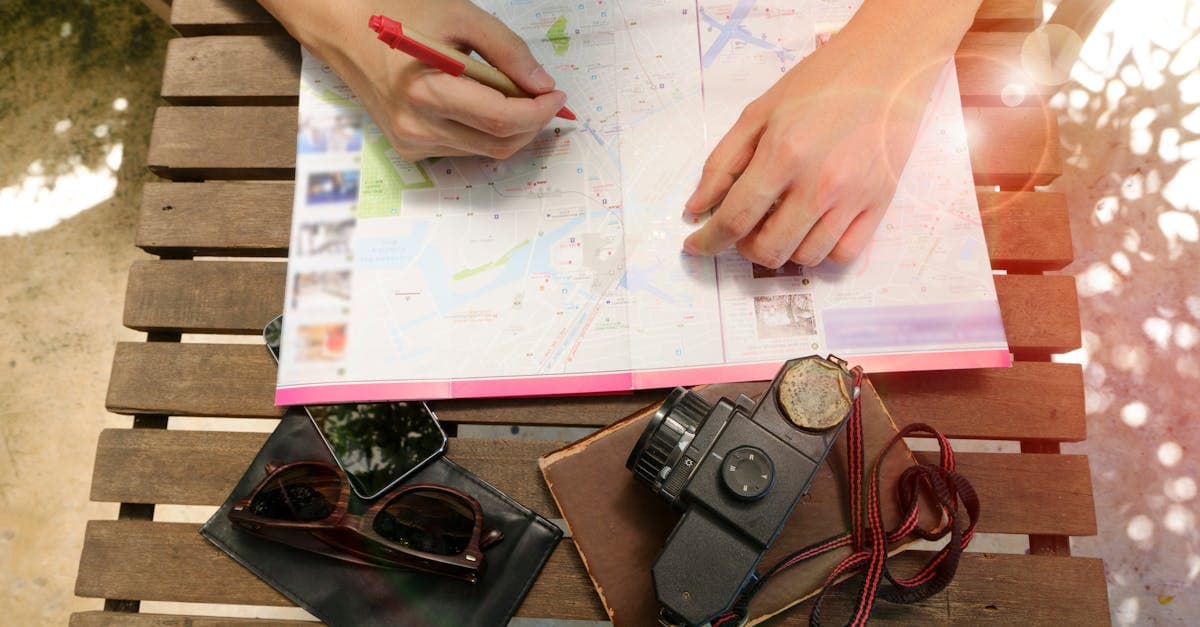 Traveler studying a map alongside a vintage camera while finalizing a Singapore itinerary