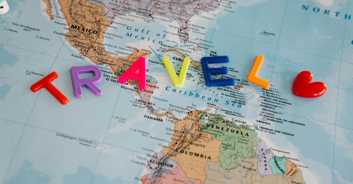 Colorful map spelling TRAVEL highlighting Central America and Caribbean travel advisory regions.