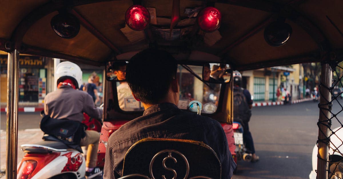 Riding a tuk-tuk through Bangkok traffic at sunset, stretching your NZ dollar on budget travel southeast asia