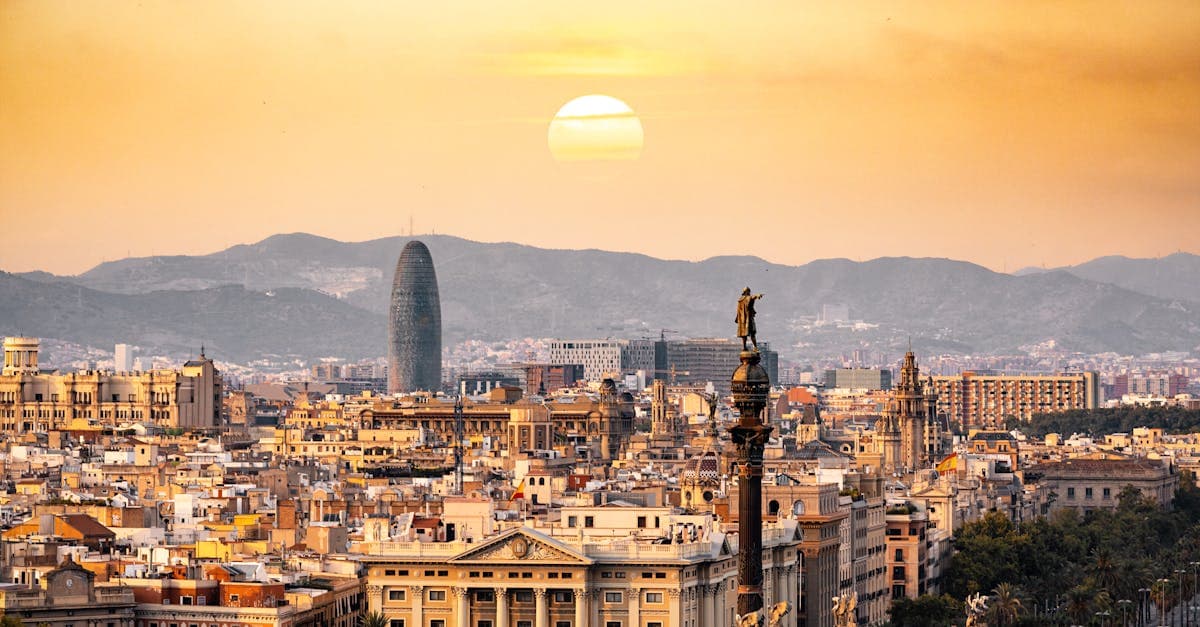 Golden hour sunset over Barcelona's skyline to help choose the best month for a barcelona holiday
