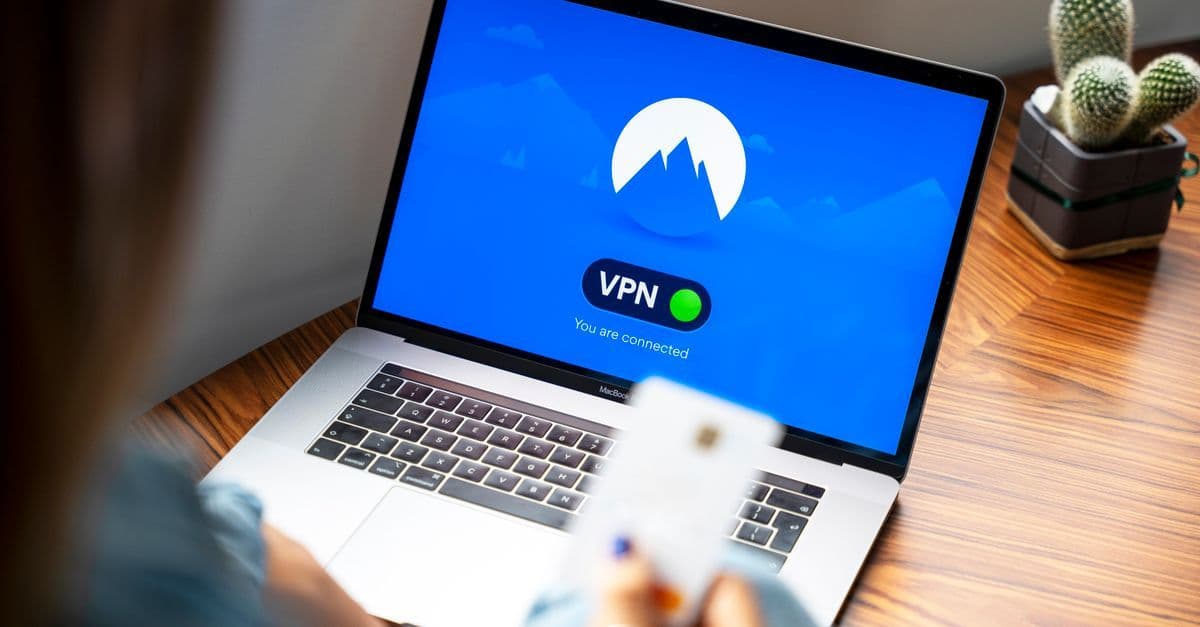 Person med laptop och VPN-anslutning för att skydda sig mot säkerhetsrisker vid offentliga wifi hotspot.