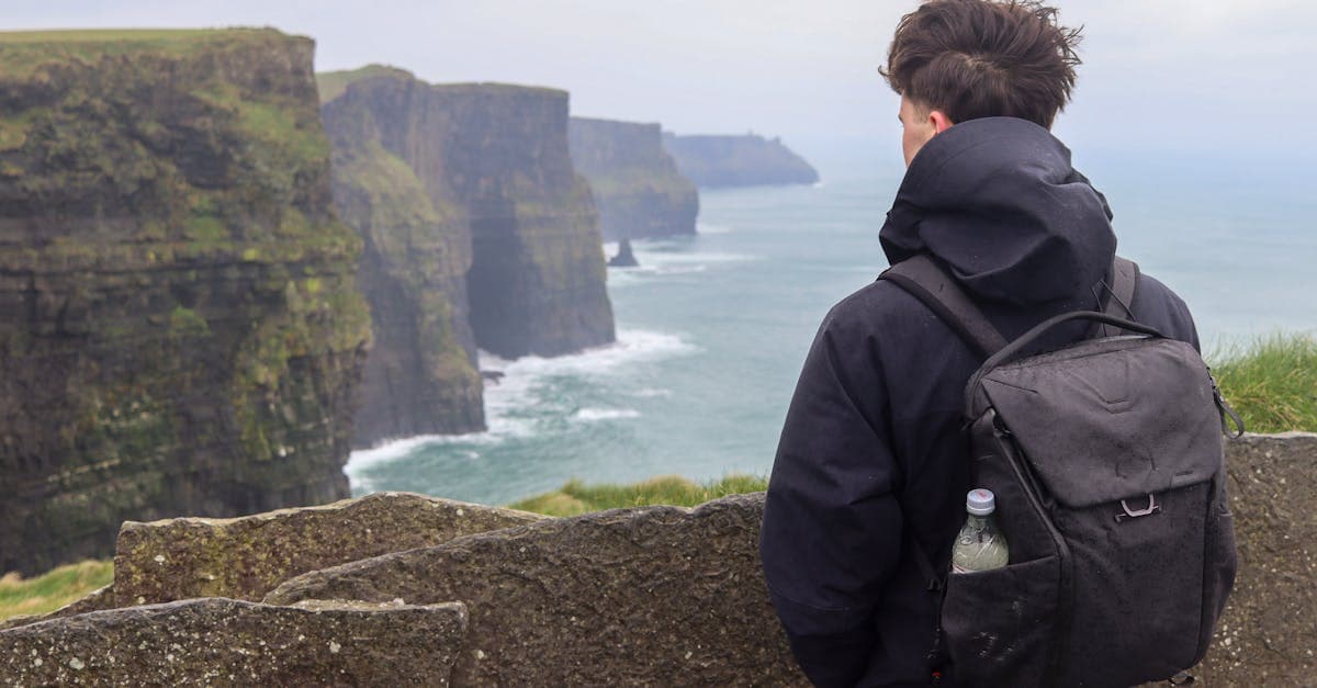 Irish solo traveller gazing at the Cliffs of Moher, where solo travel in Europe truly begins
