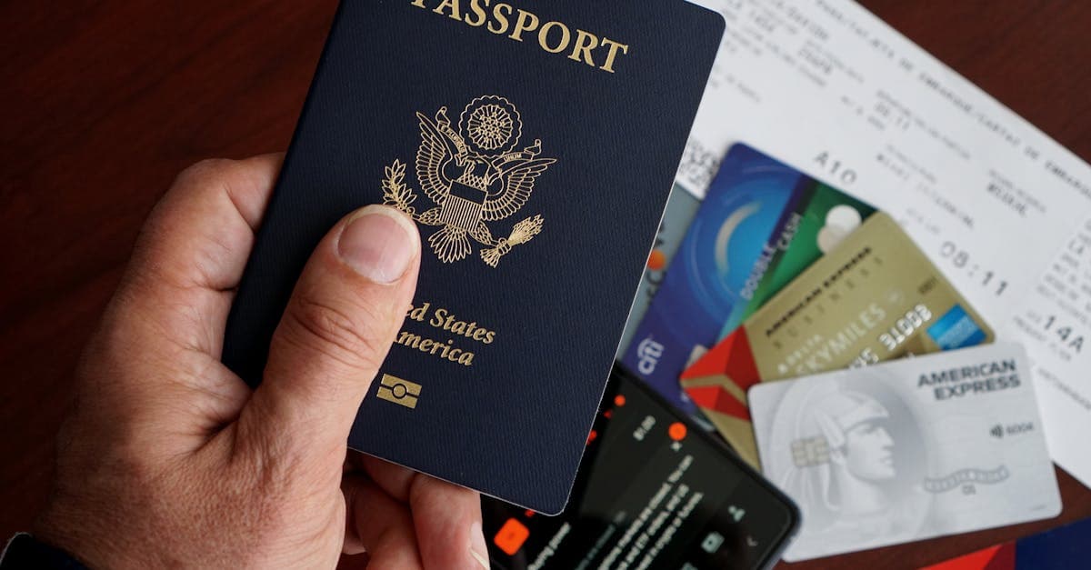 US passport, credit cards, travel tickets, and smartphone laid out as documents required for a visa interview