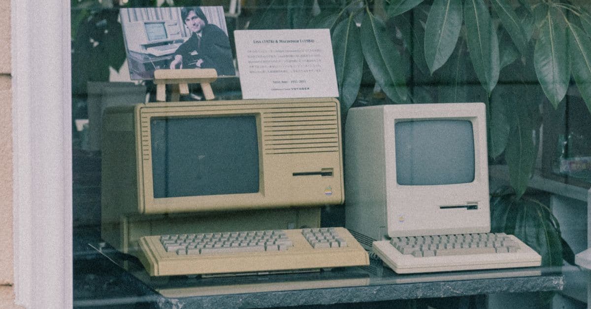 Vintage Apple computers on display in a Tokyo shop window, evoking early personal computing history