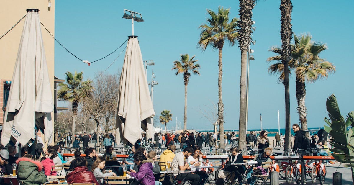 Colourful beachside café in Barcelona with locals and visitors enjoying a sunny afternoon together