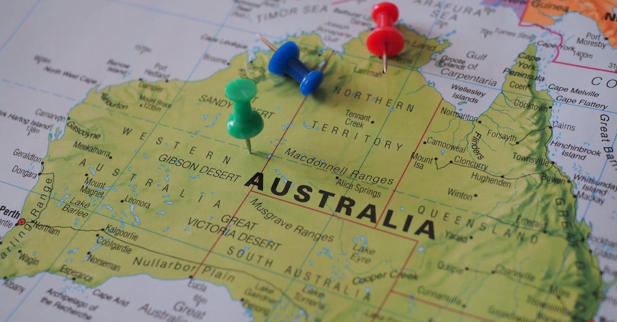 Colourful pushpins marking travel destinations across an Australian map in a hello roam vs travel eSIM quick verdict comparison.