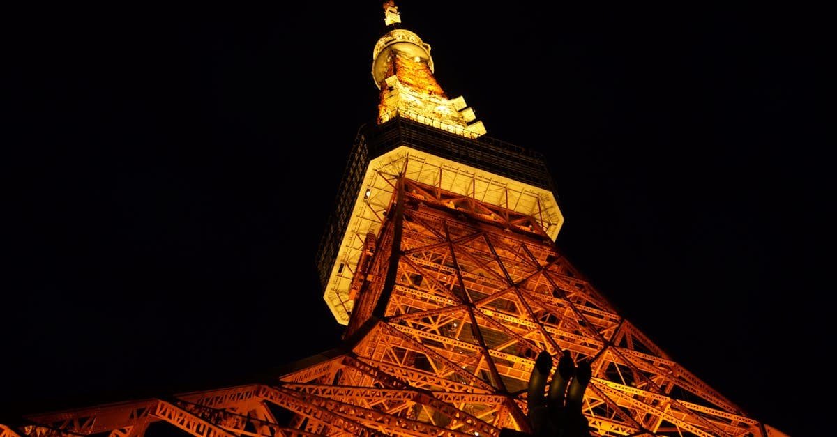 Brightly lit Tokyo Tower reflected in the city skyline, a must-see among things to do in Tokyo