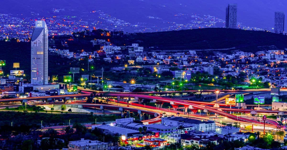 Monterrey Mexico city lights glowing at night with a panoramic view of its modern skyline