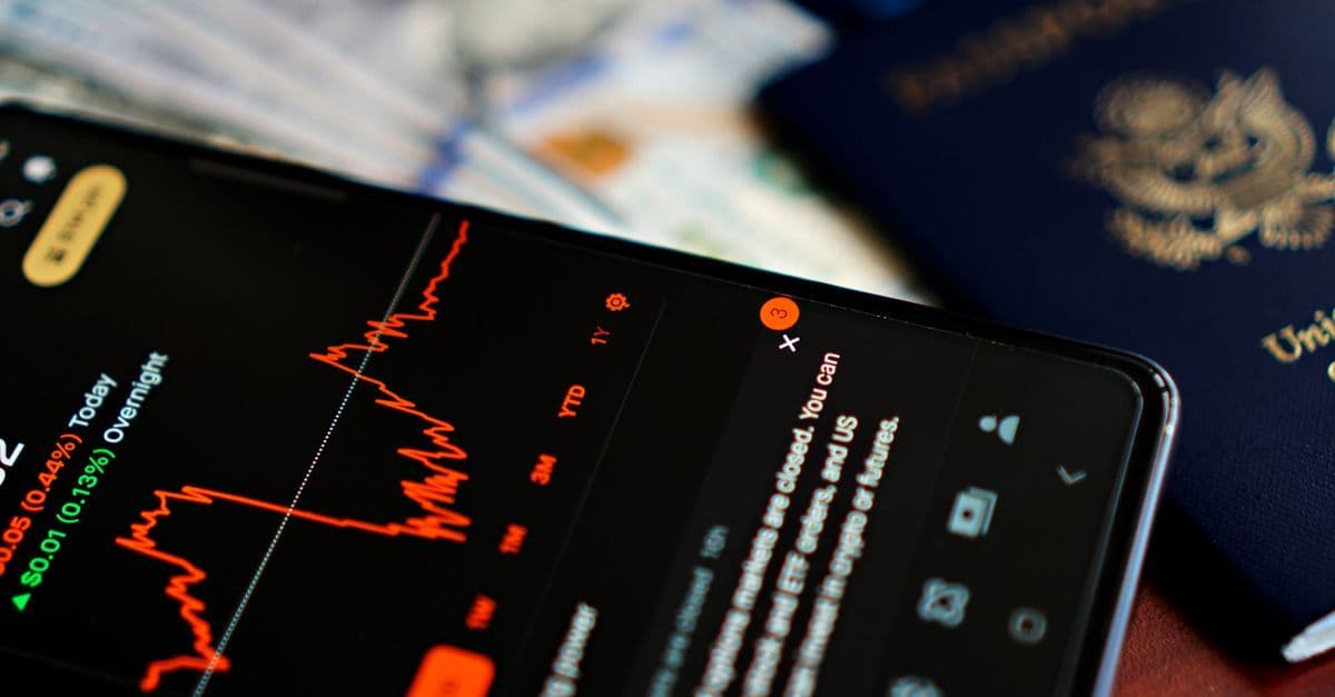 Smartphone showing data usage beside a US passport and cash, representing running out of data abroad.