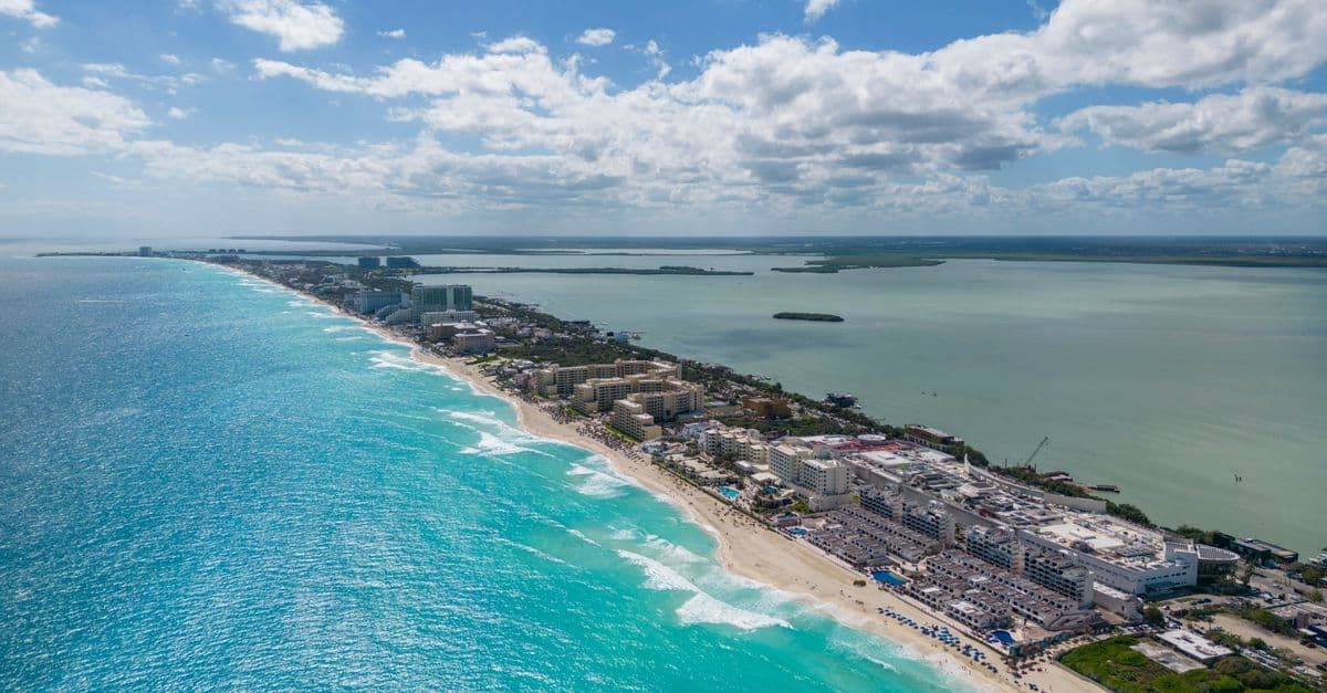 Cancun's coastline and hotel zone under clear skies, showcasing calm weather during the best time to visit Cancun