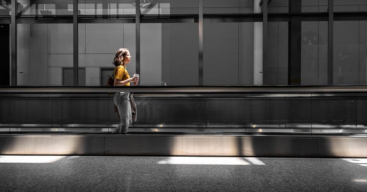 A traveller walks along a moving walkway in an airport terminal in Toronto.