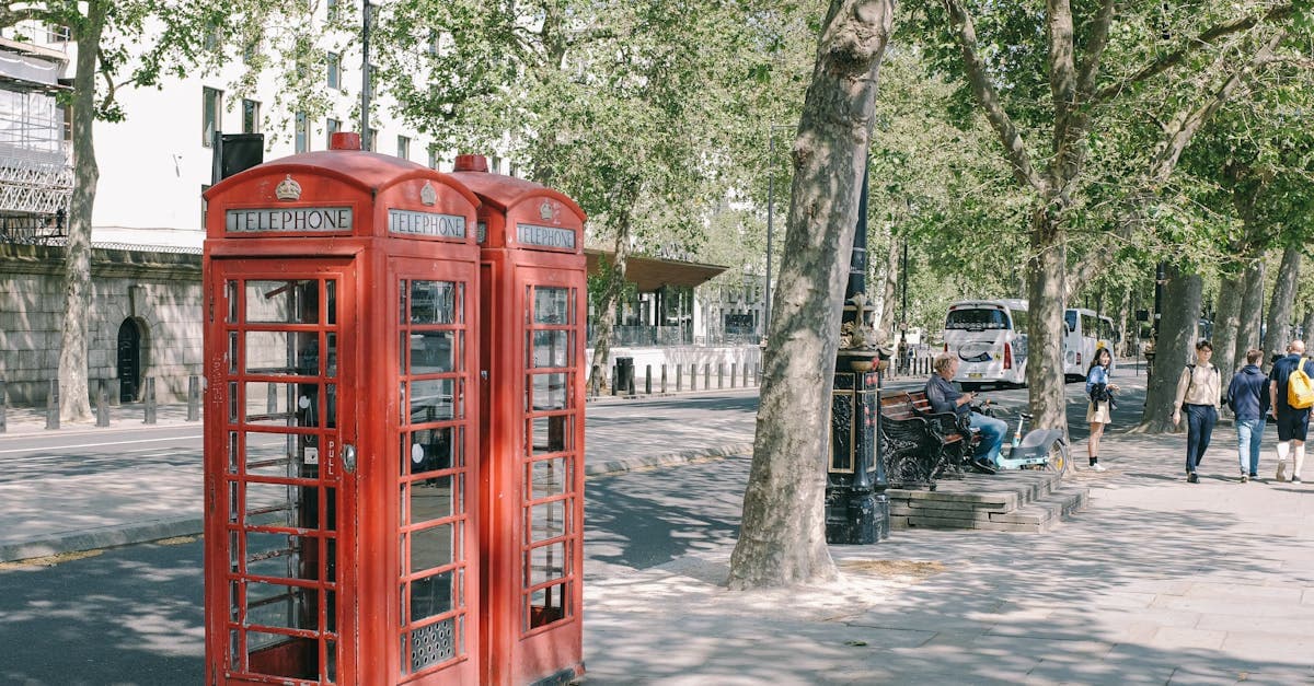 Classic red telephone booths on a sunny London day, a symbol of staying connected in England