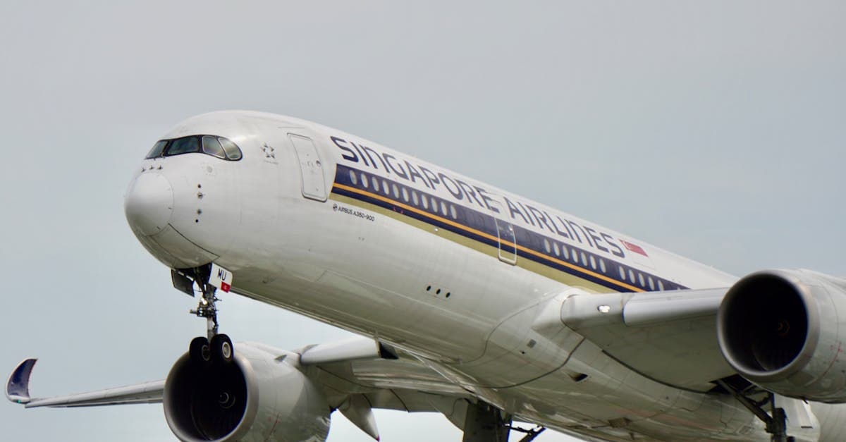 Singapore Airlines Airbus A350 in flight, representing peak season periods to avoid when booking Sydney to Singapore.