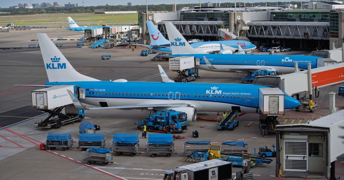 KLM aircraft lined up at Schiphol Airport terminal, a key gateway for amsterdam holidays from UK airports.