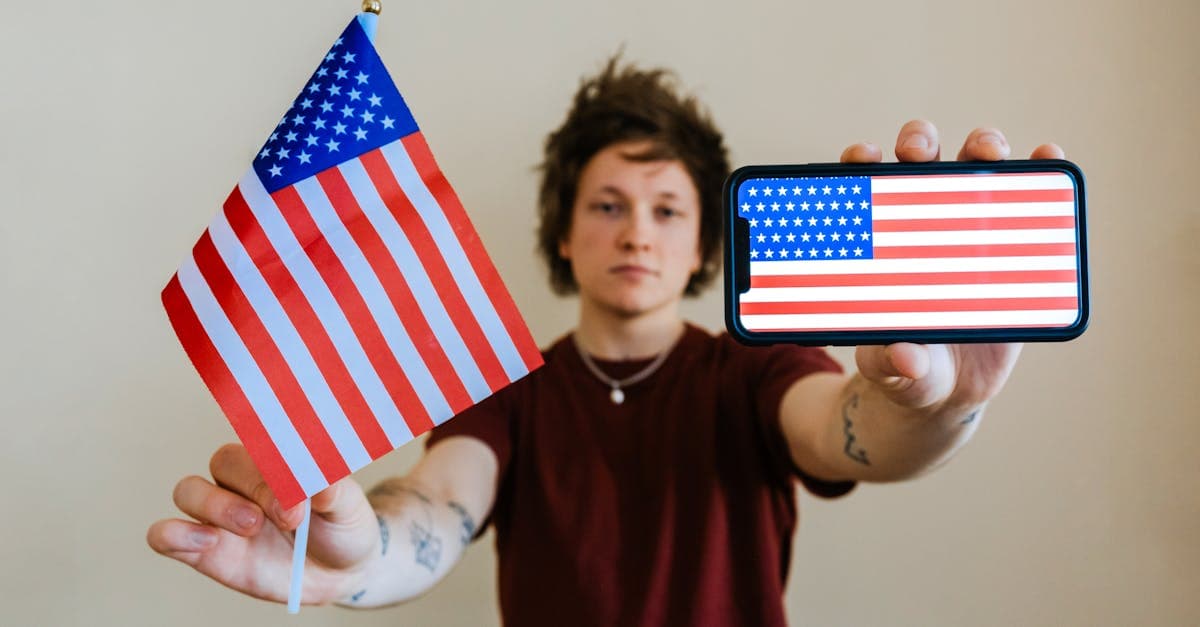 Person holding an American flag and smartphone, celebrating connectivity after receiving US visa approval