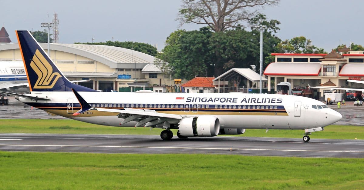 Singapore Airlines jet taxiing at Sydney Airport, preparing for departure to Singapore.