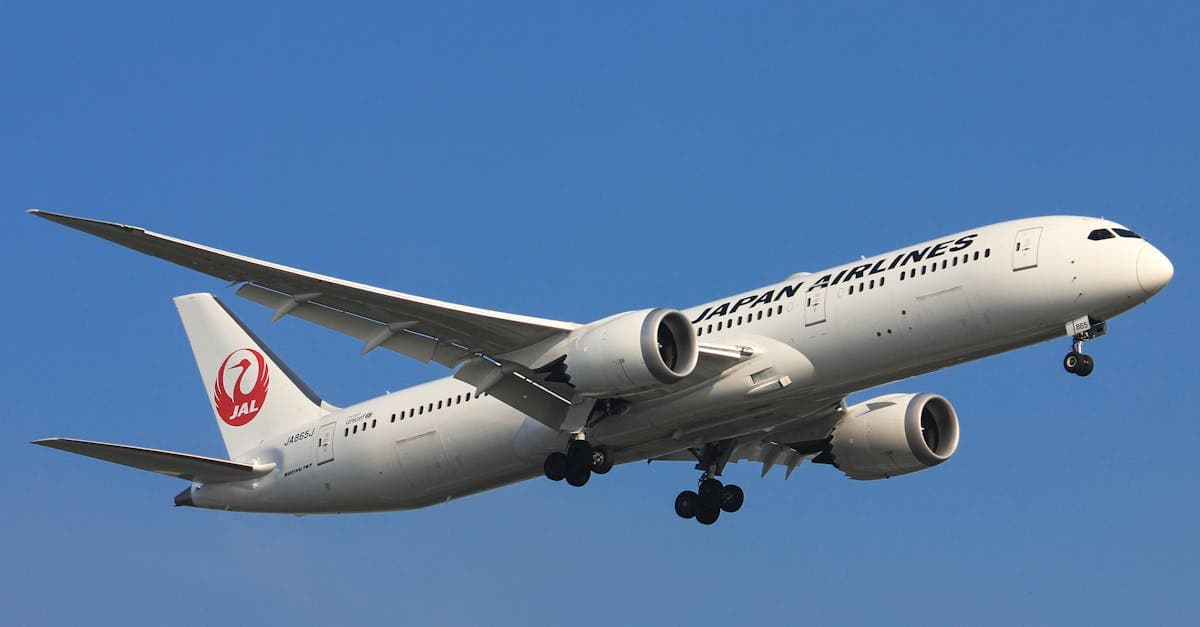 Japan Airlines Boeing 787 Dreamliner against clear blue sky on a direct UK to Japan route