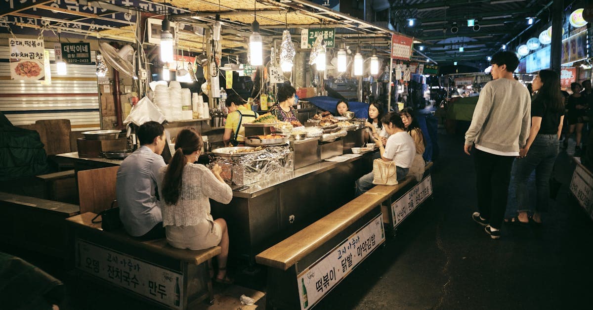 ソウルの賑やかな夜市で韓国グルメを楽しむ人々、屋台から高級店まで多様な価格帯
