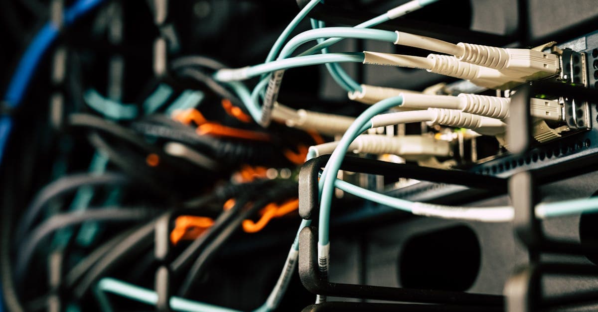 Tangled network cables connected to server rack equipment powering Vodafone broadband infrastructure across the UK.
