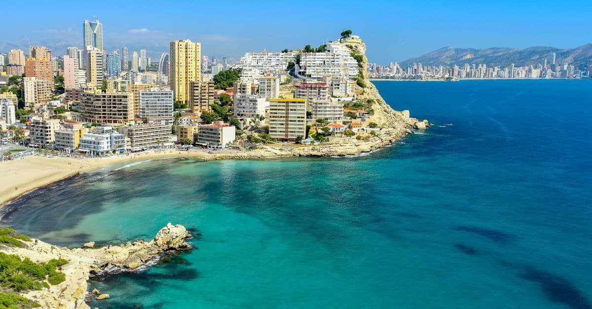 Peaceful aerial view of Benidorm's blue sea and skyscraper coastline during the quieter spring season