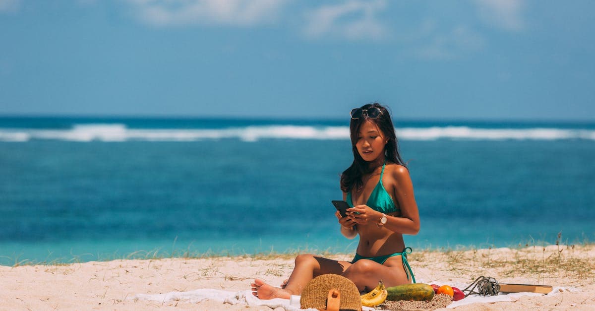 Woman relaxing on a Fiji beach, staying connected with a travel eSIM during a tropical island getaway