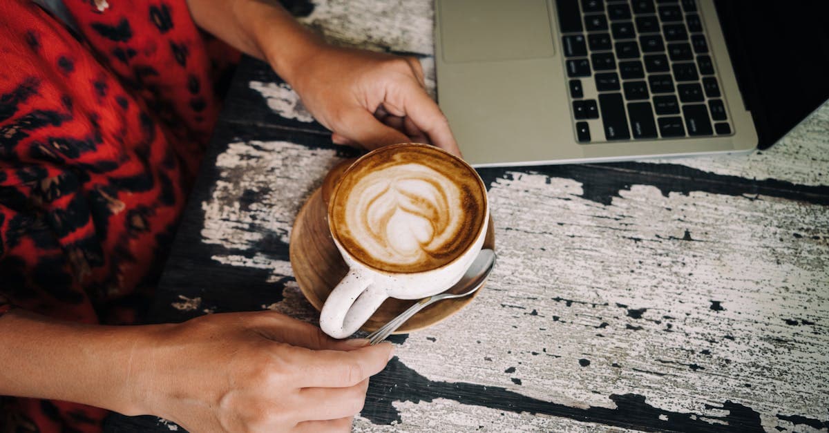 Remote professional with latte art and laptop at a cosy Bali café, working abroad in Bali daily
