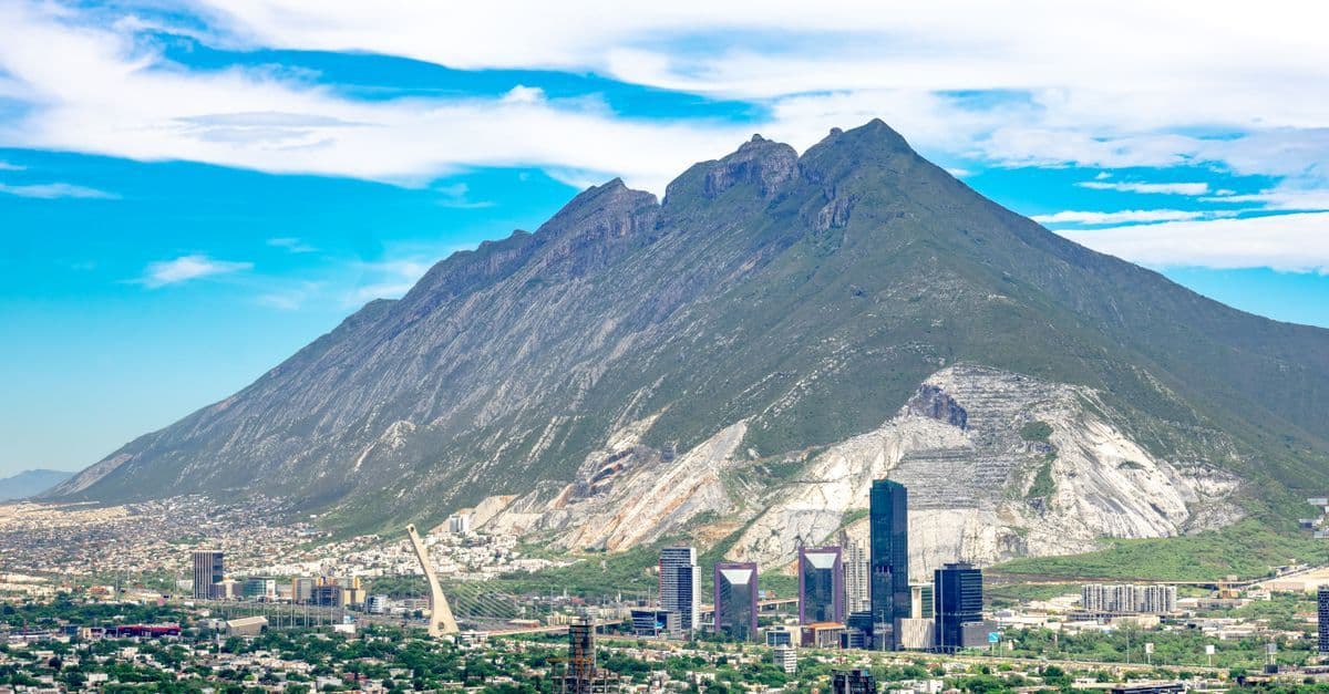 Aerial panoramic view of Monterrey Mexico cityscape with the iconic Cerro de la Silla mountain backdrop