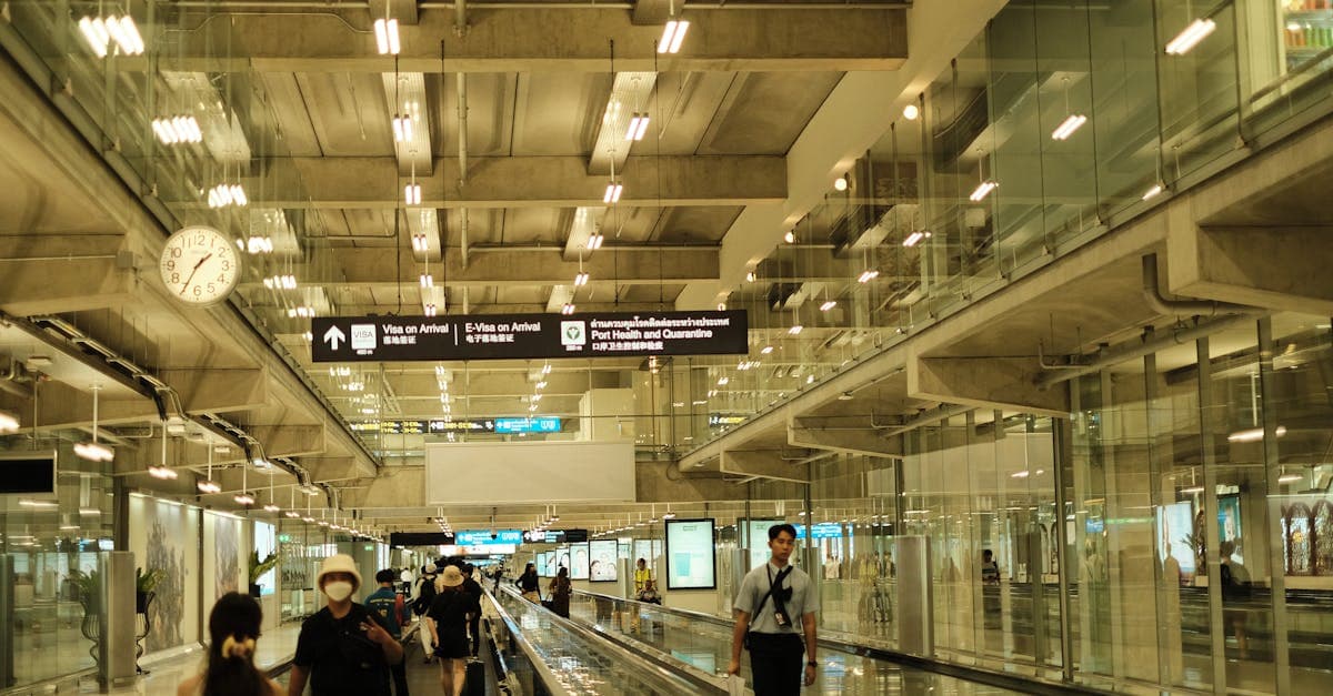 Travellers walking through modern airport terminal after submitting malaysia arrival card at Causeway![image