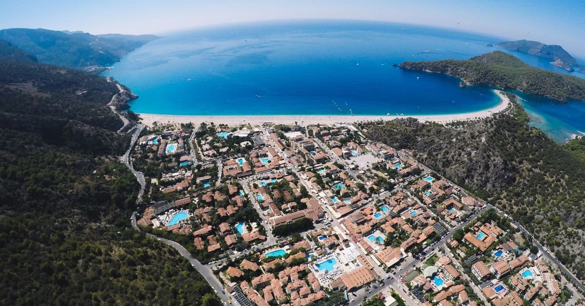 Aerial view of Ölüdeniz, Turkey, with its resort town, crescent beach and bright blue bay.