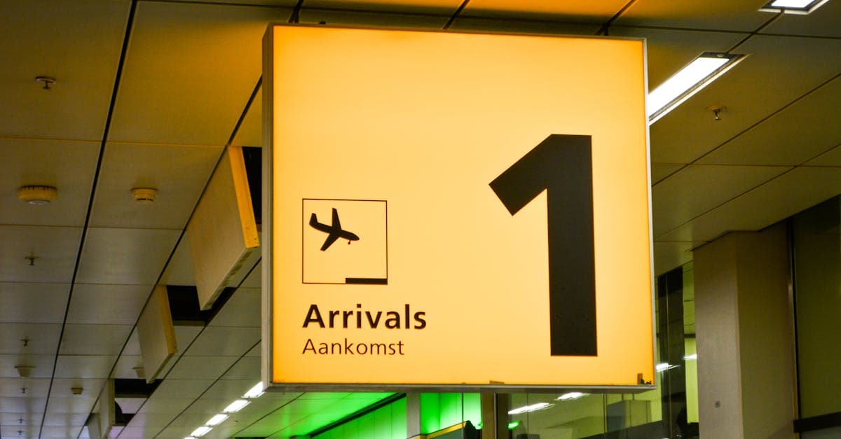 Bright arrivals sign with airplane symbol in an airport terminal.