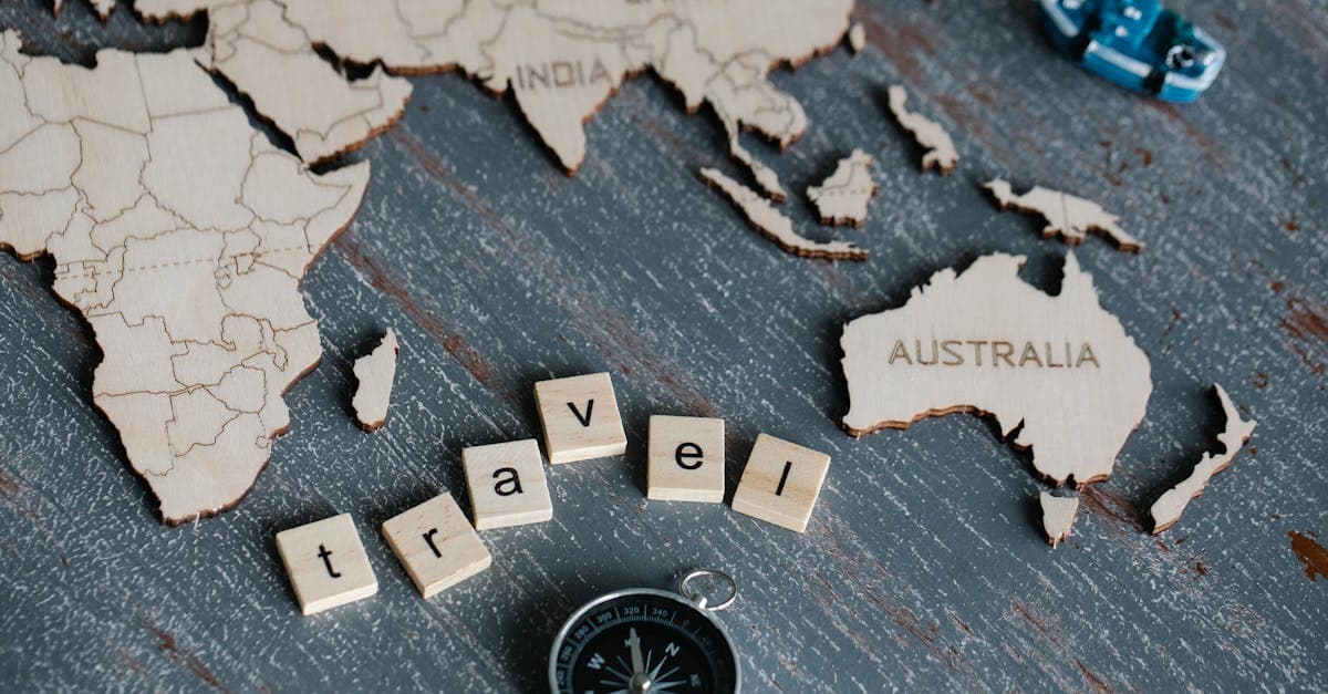 Wooden world map with compass and scrabble letters spelling travel, planning a multi-country trip with a travel eSIM