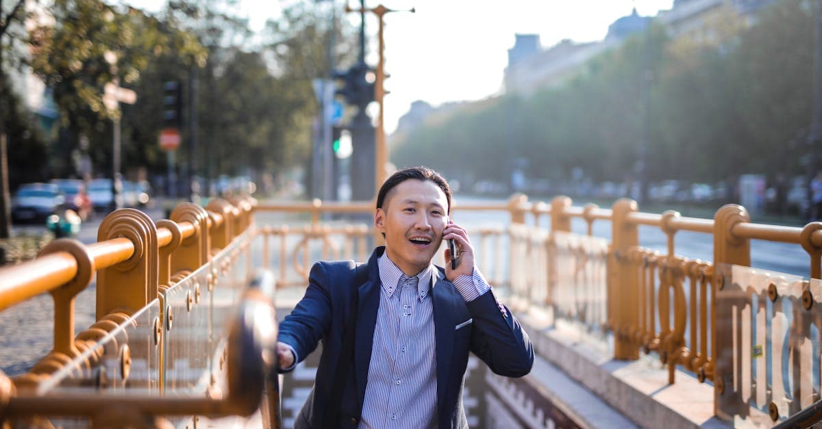 Businessman checking phone eSIM Japan compatibility near a city subway entrance before travelling from New Zealand