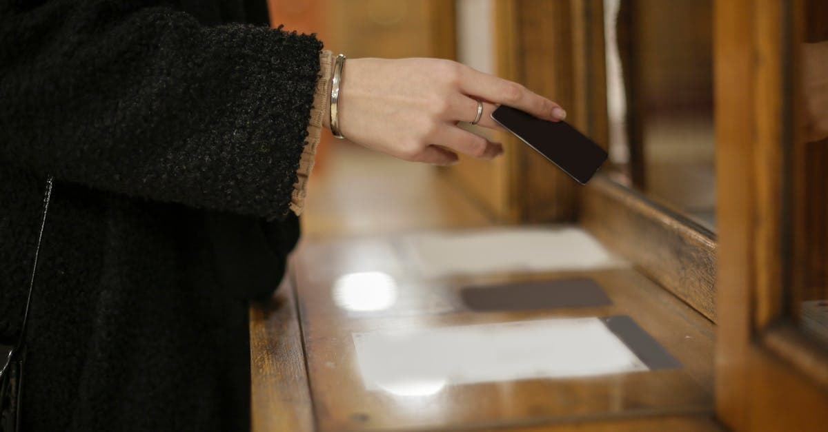 Woman purchasing a travel sim card at a Singapore retail counter using contactless payment.