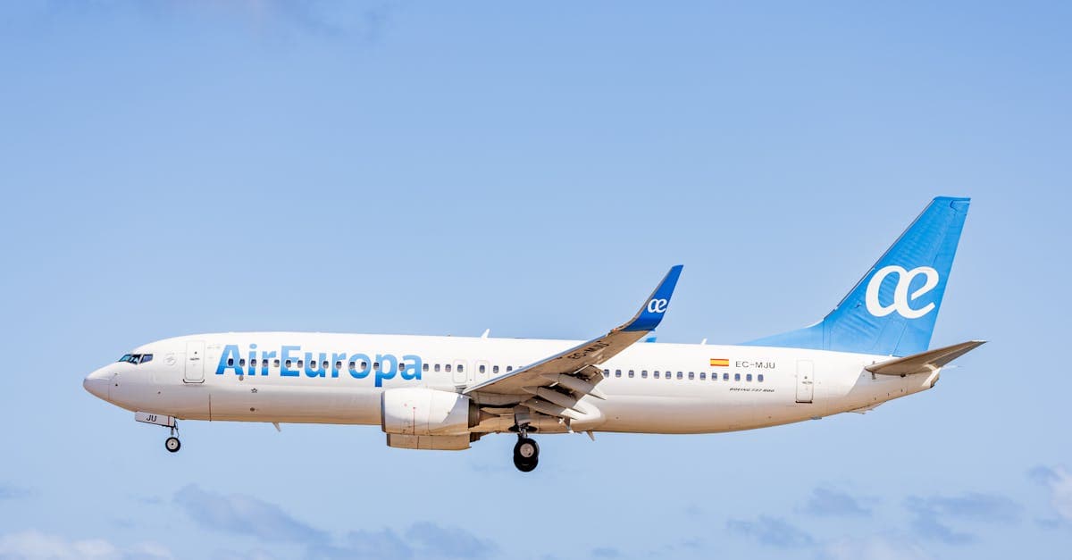 Air Europa aircraft flying against a vast blue sky, captured in broad daylight.