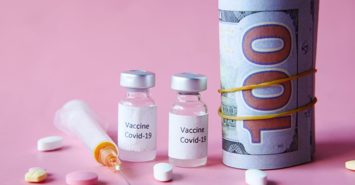 Travel vaccinations cost breakdown shown with vaccine vials, Canadian currency, and medication on pink background