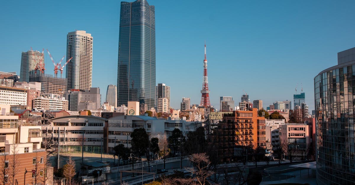 Daytime view of Tokyo Tower rising above modern buildings, helping plan three days of things to do in Tokyo
