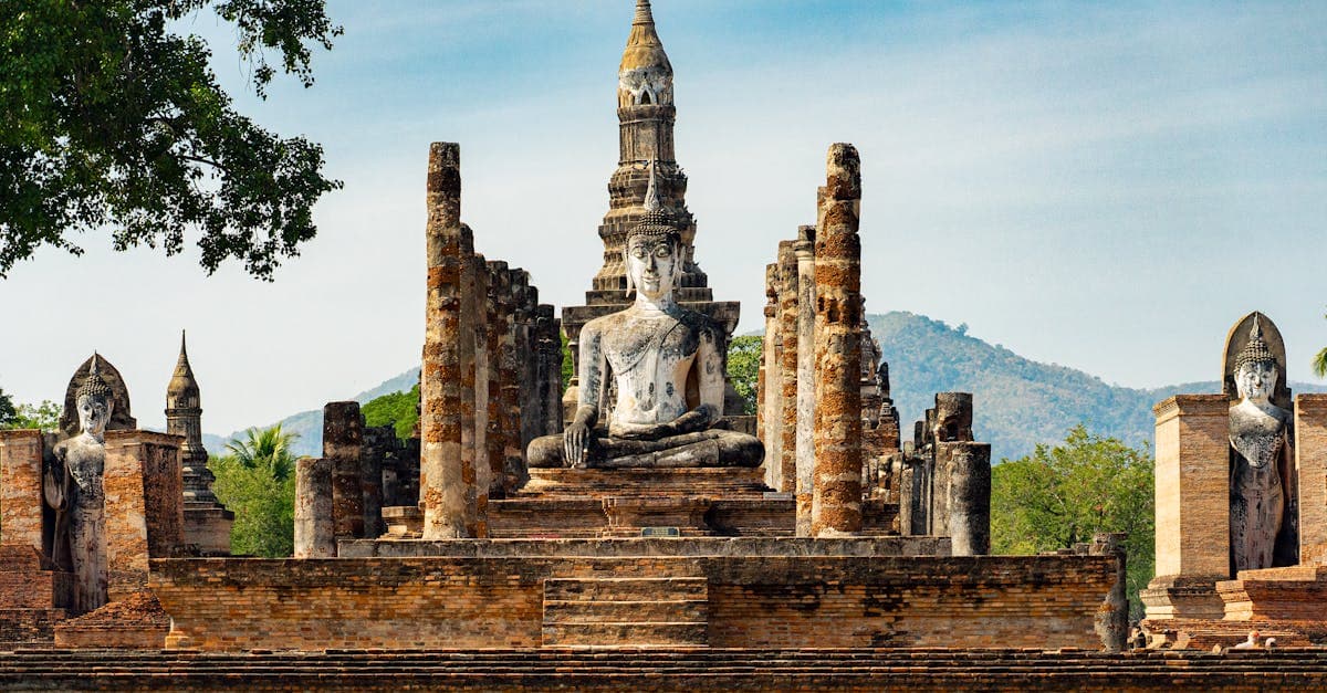 Atmospheric ruins of Wat Mahathat temple in Sukhothai, a UNESCO World Heritage site covered in any thailand travel guide