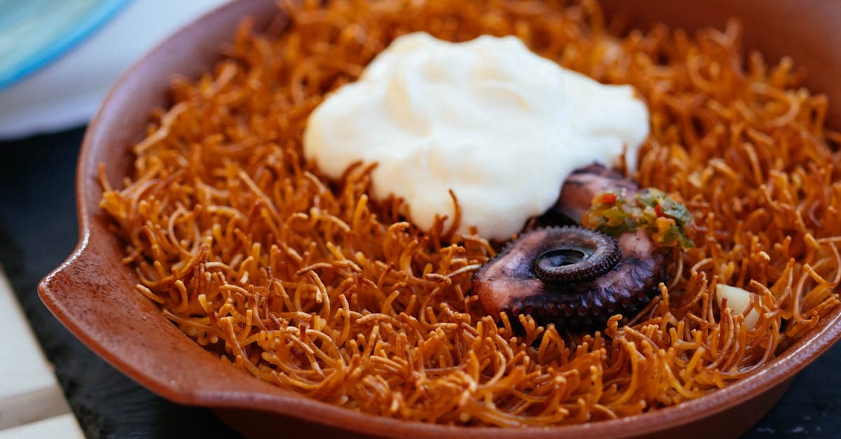 Tender octopus on crispy vermicelli topped with aioli, a flavoursome example of typical Spanish lunch food