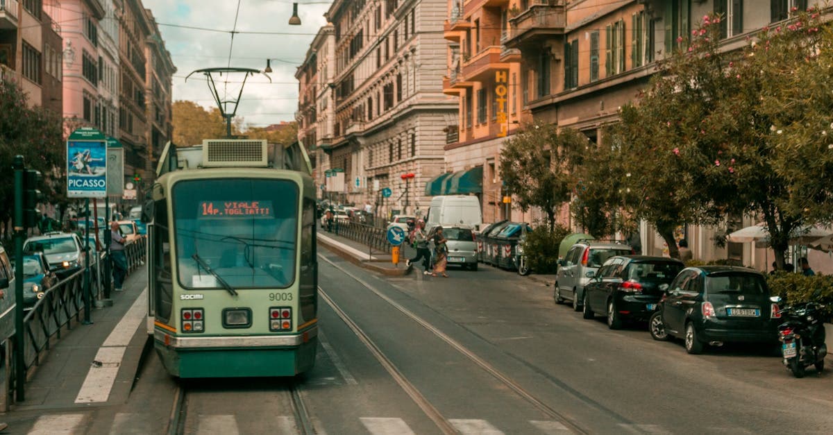 A vintage tram passing through Rome's busy streets lined with classic Italian architecture