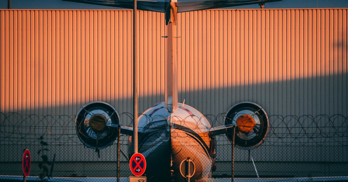 Twin jet airplane parked on Nürnberg airport apron at sunset.