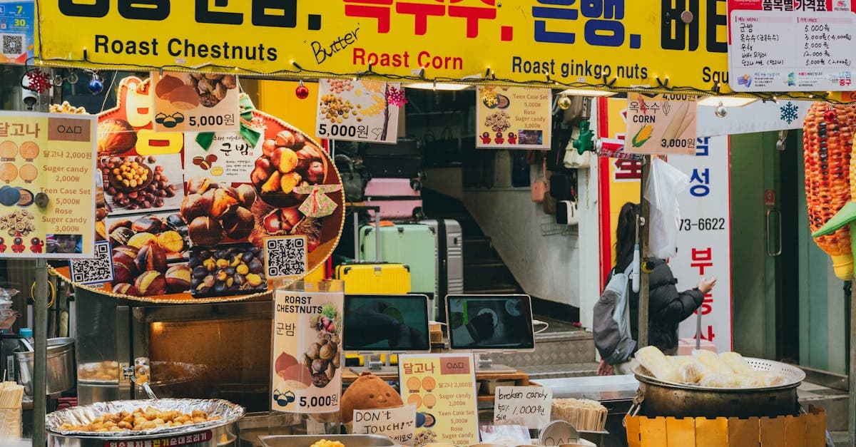 Korean street food stall selling roasted chestnuts and corn in a lively Seoul market environment.