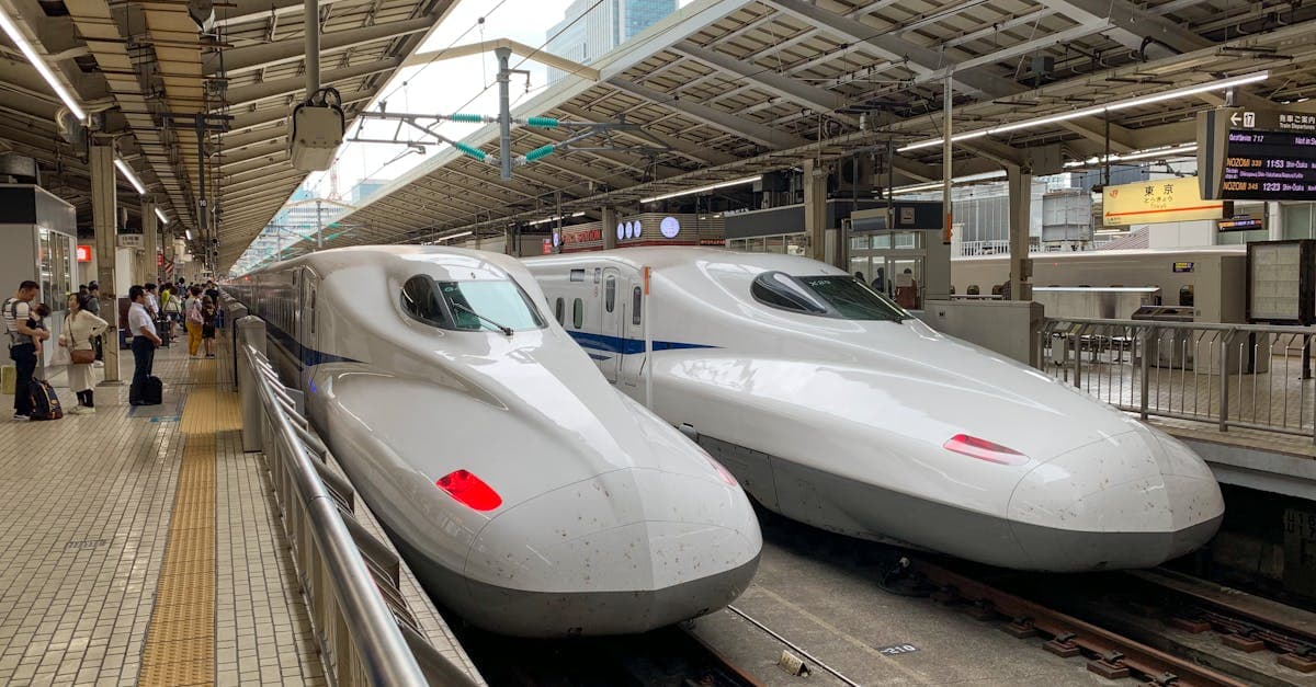 Two sleek shinkansen bullet trains at Tokyo Station, the fastest and most efficient way to travel Japan solo