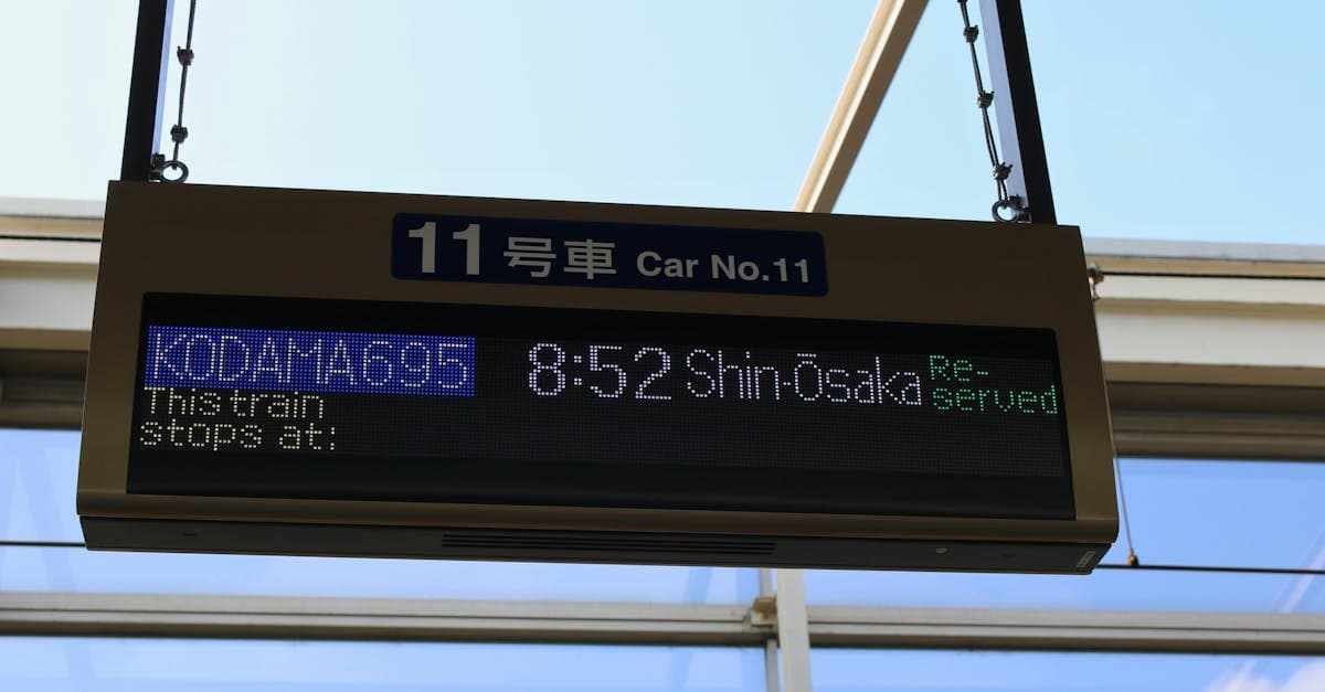 Digital train departure board at Kyoto Station showing Shinkansen times, essential for planning things to do in Japan